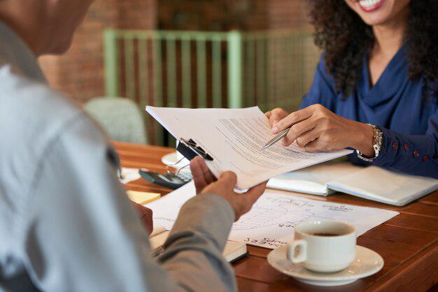 A person signing documents for a bilingual criminal defense attorney in Tijuana, Mexico