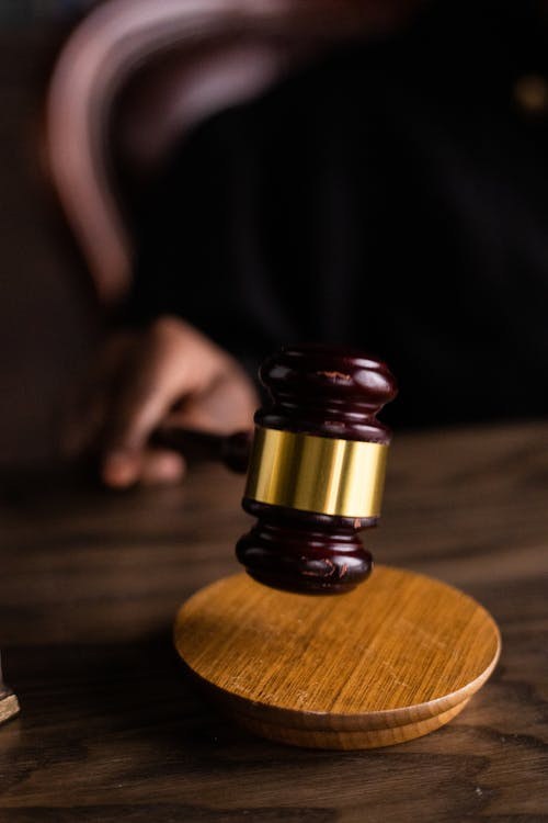 A person holding a gavel in their hand