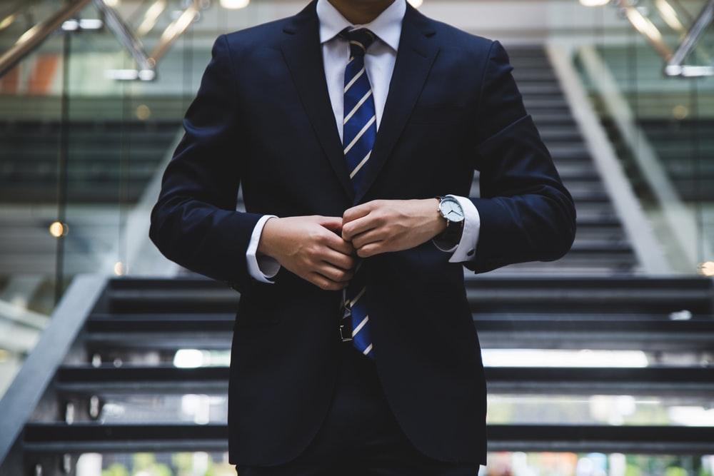 A man buttoning a suit